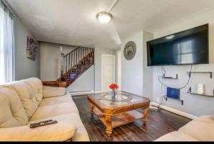 a living room with a couch and a coffee table at Comfortable home away from home in East Hartford