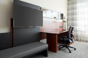 an office with a desk and a chair at Marriott Montreal Airport In-Terminal Hotel in Dorval