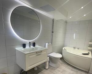 uma casa de banho com um lavatório, WC e um espelho. em Ringarstigen 29 em Gävle