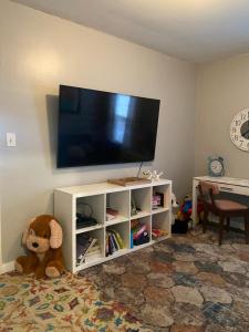 a living room with a flat screen tv on a white cabinet at Cozy, 1st floor apartment 2bdrms Plus Semi Private room with Futon Pets with fee Family Friendly Close to Everything in Cleveland
