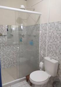 uma casa de banho com um WC e uma cabina de duche em vidro. em Casa 2 Cantina Florêncio São Pedro da Serra em Nova Friburgo