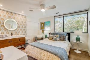 a bedroom with a bed and a sink and a mirror at The Novel Retreat in Austin