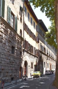 a stone building with a yellow car parked next to a street at My Boutique Home in Florence in Florence