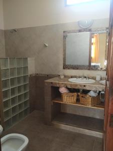 a bathroom with a sink and a mirror at Departamentos Centro in Villa Dolores