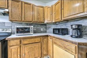 a kitchen with wooden cabinets and a microwave at downtown and secluded in Manchester