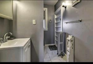 a bathroom with a sink and a towel rack at downtown and secluded in Manchester