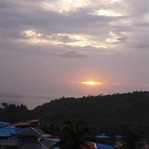 a sunset over a city with houses and trees at Le Luminous, Home Stay in Port Blair
