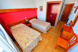 Posteľ alebo postele v izbe v ubytovaní Hostal Magnolia