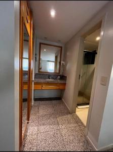 a bathroom with a sink and a mirror at Cond Blue Tree Towers in Fortaleza