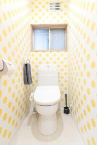 a bathroom with a toilet in a polka dot wall at LAINA MINOH＊1棟貸切＊ in Minoo