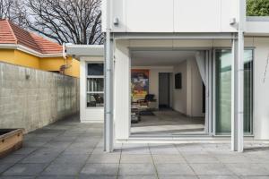 a glass extension to a house with a patio at Lavender Box in Dunedin