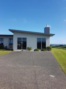 a house with a driveway in front of it at House on the Hill in New Plymouth