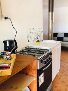 a kitchen with a stove and a counter top at Linda Casa en Carretera Austral in La Junta