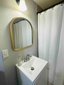 a bathroom with a sink and a mirror at Coral Gables Miami Studio near Airport and Beaches in Miami