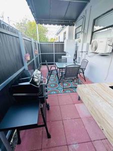 a patio with a table and chairs and a bench at Coral Gables Miami Studio near Airport and Beaches in Miami