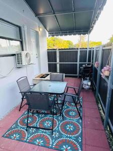 a patio with a table and chairs on a deck at Coral Gables Miami Studio near Airport and Beaches in Miami