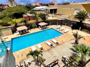 an overhead view of a swimming pool with chaise lounges at Las Islas #12 in Palm-Eagle Beach