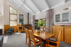 a dining room with a wooden table and chairs at River Retreat, spa, pets, Wi-Fi in Turangi