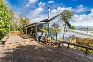 a home with a large deck with a house at River Retreat, spa, pets, Wi-Fi in Turangi