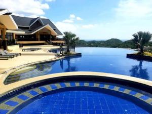 a large swimming pool in front of a house at Keira 208, Alta Vista De Boracay in Boracay