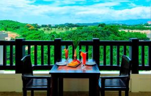 a table and chairs on a balcony with a view at Keira 208, Alta Vista De Boracay in Boracay