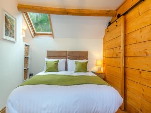 a bedroom with a large bed and a window at Yr Allt in Abergele