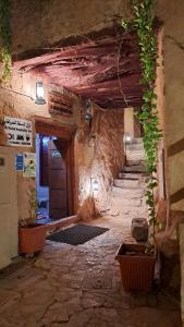 an old stone building with a hallway with a door at Al Misfah Hospitality Inn in Misfāh