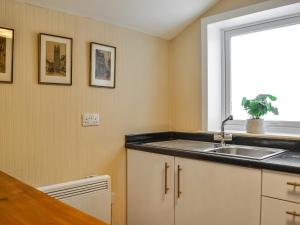 a kitchen with a sink and a window at George Apartment 54 in Whithorn