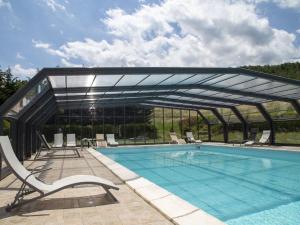 a swimming pool with a retractable canopy over it at Property in Trivigno PZ in Trivigno
