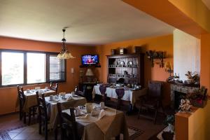 a dining room with tables and chairs and a tv at Bed And Breakfast Marina d'Aspra in Bagheria