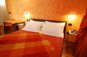 Кровать или кровати в номере I Tre Merli Locanda