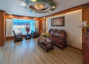 a living room with leather chairs and a table at Hotel Nhu Y 2 in Ho Chi Minh City