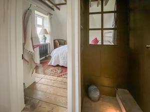 a hallway with a door leading to a bedroom at Campbell Cottage in Ticehurst