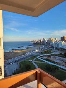 a balcony with a view of the ocean and a city at Nuevo estudio al mar con cochera in Mar del Plata
