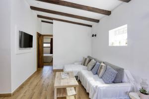 a white living room with a couch and a table at Apartments by the sea Jezera, Murter - 19056 in Jezera