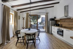 a kitchen and dining room with a table and chairs at Apartments by the sea Jezera, Murter - 19056 in Jezera