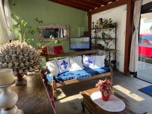 uma sala de estar com um sofá e uma mesa em Magnu´s Pousada em Paraty