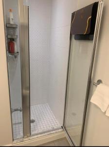 a shower with a glass door in a bathroom at YAMA Luxury Condo 2B2B FreeParking in Markham