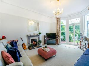 a living room with a couch and a fireplace at Hillside in Paignton