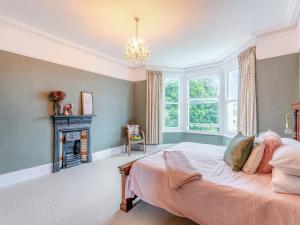 a bedroom with a bed and a fireplace at Hillside in Paignton