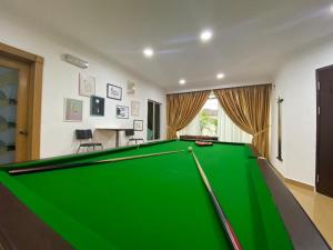 a pool table in a living room with at Kajang Pool Party Villa in Kajang