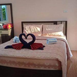 a bed with a heart made out of towels at Phujhaofa villa club ( ไสยวน) in Ban Saiyuan (1)