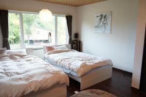 Ένα ή περισσότερα κρεβάτια σε δωμάτιο στο Niseko Hotel KIRAKU NAGI 車利用にオススメ 各スキー場迄車で約15分