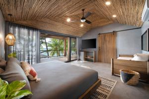 a bedroom with a large bed and a couch at Arca in Roatan