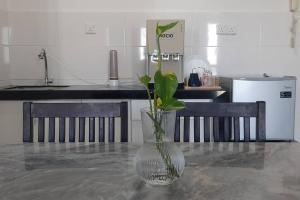 a vase with a plant in it sitting on a table at mozhouze studio @ 8 Kinrara Service Apartment in Puchong