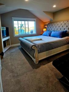 a bedroom with a large bed and a window at 4 Story Lakeside Home In Heart of Lake Union - Queen Anne Neighborhood in Seattle