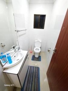 a bathroom with a sink and a toilet at Large 3 bedroom villa with Pool in Sonaisali Nadi in Nadi