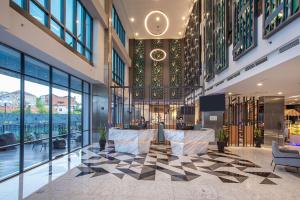 a lobby with a table in a building at THE 1O1 Jakarta Airport CBC in Tangerang