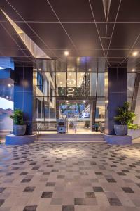 an empty lobby of a building with potted plants at THE 1O1 Jakarta Airport CBC in Tangerang