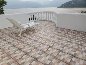 a white bench sitting on top of a tile floor at El Castillo en el Lago Atitlán in San Marcos La Laguna